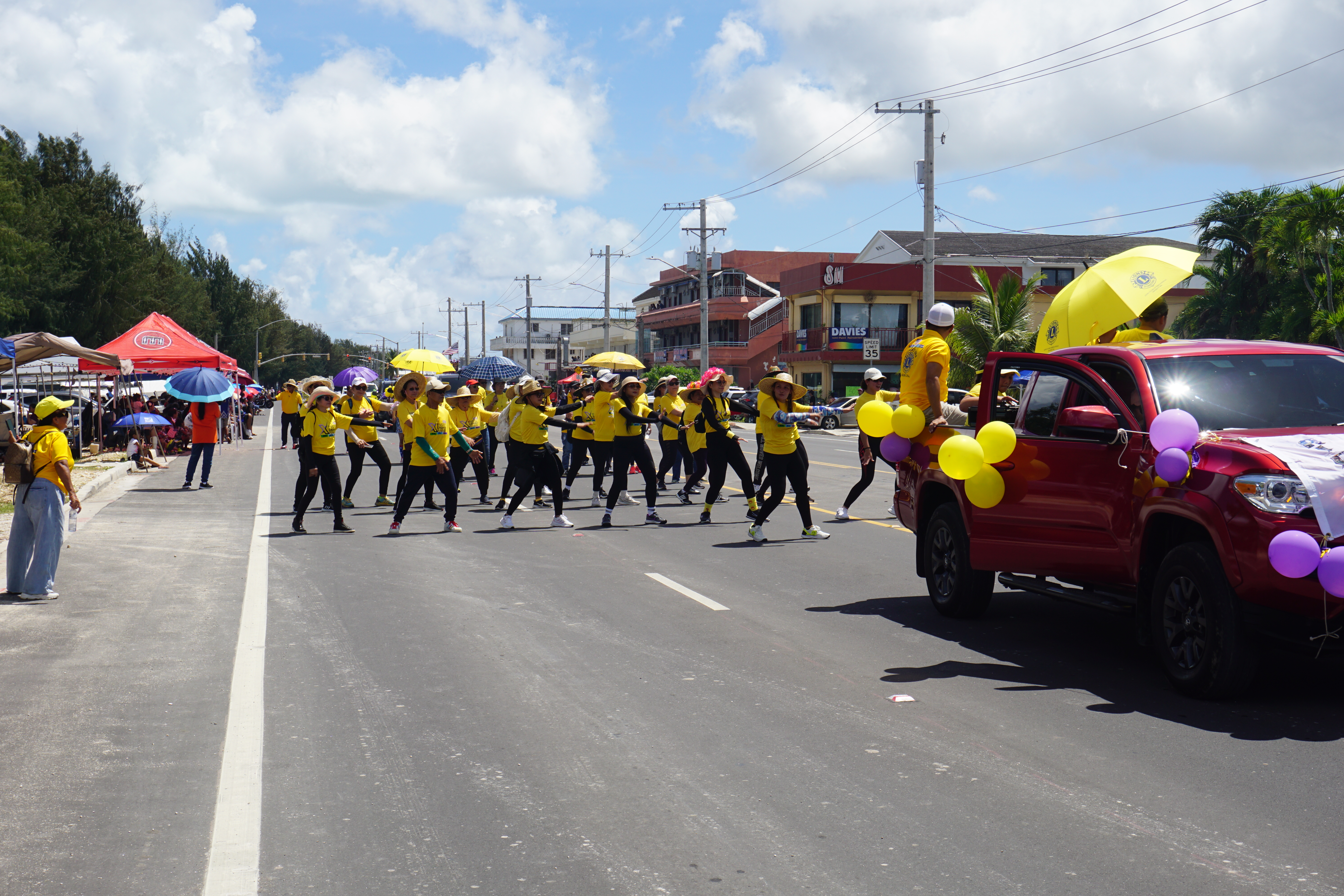 Marchers with the Lions Club perform a dance number.