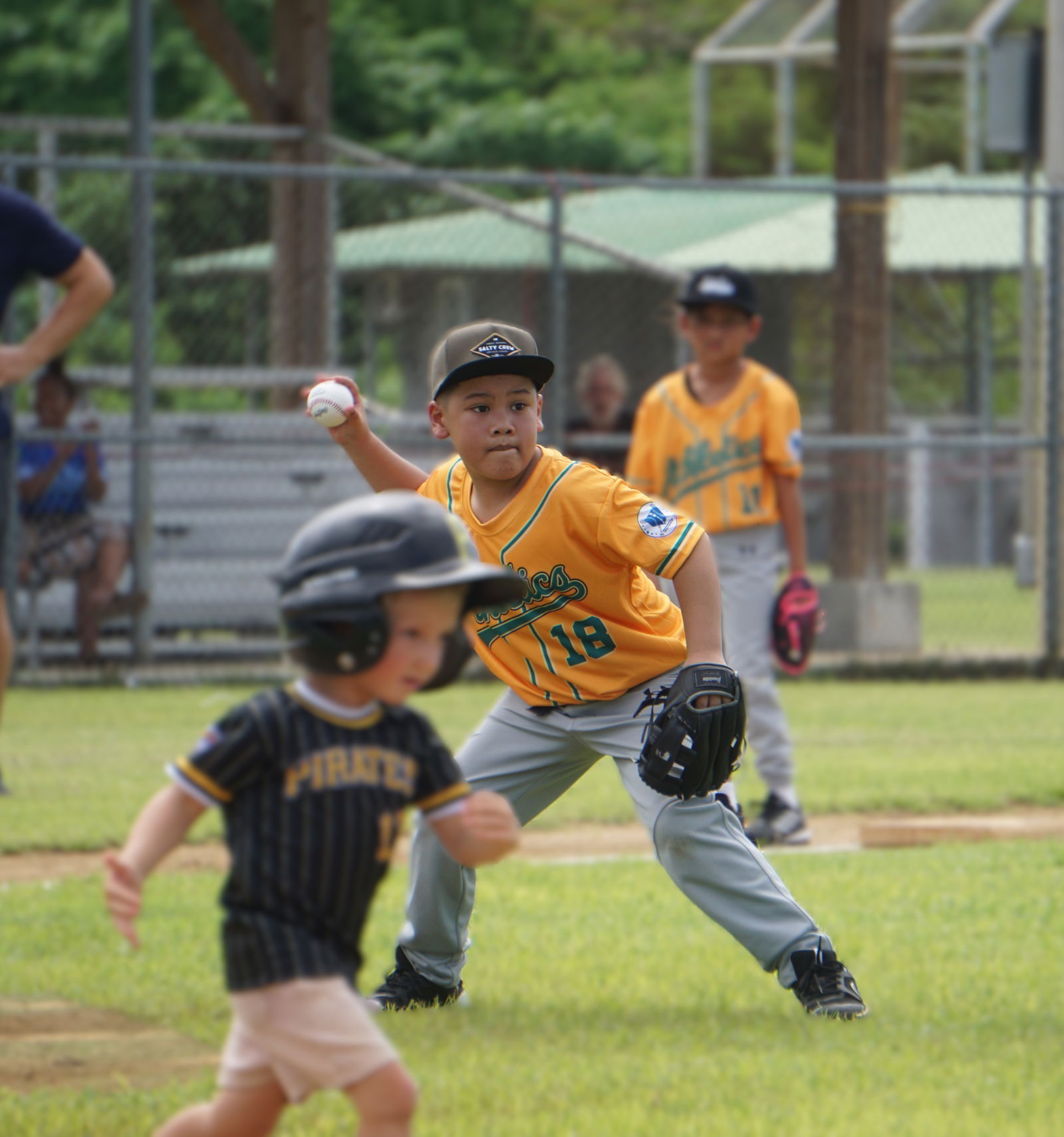 The Athletics’ Lyle Deleon Guerrero winds up for a throw to first base for a pickoff during a game in the Northern Mariana Islands Softball Association’s 2nd Annual Summer T-Ball League at the Miguel "Tan Ge" Pangelinan Ball Field.Photo by James F. Sablan Jr.