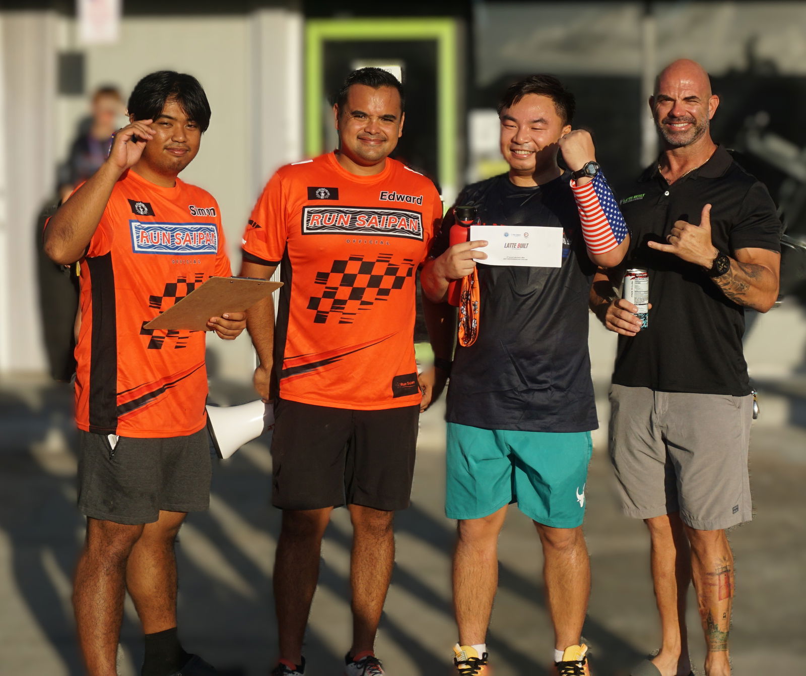 Brian Li poses with Run Saipan's Simon Necesito and Edward Dela Cruz Jr. along with Latte Built owner Derek Cutting as the winner of the theme costume challenge of the July 4th Independence Day 2-Mile Race 2025 at the Latte Built gym on Friday morning.Photo by James F. Sablan Jr.