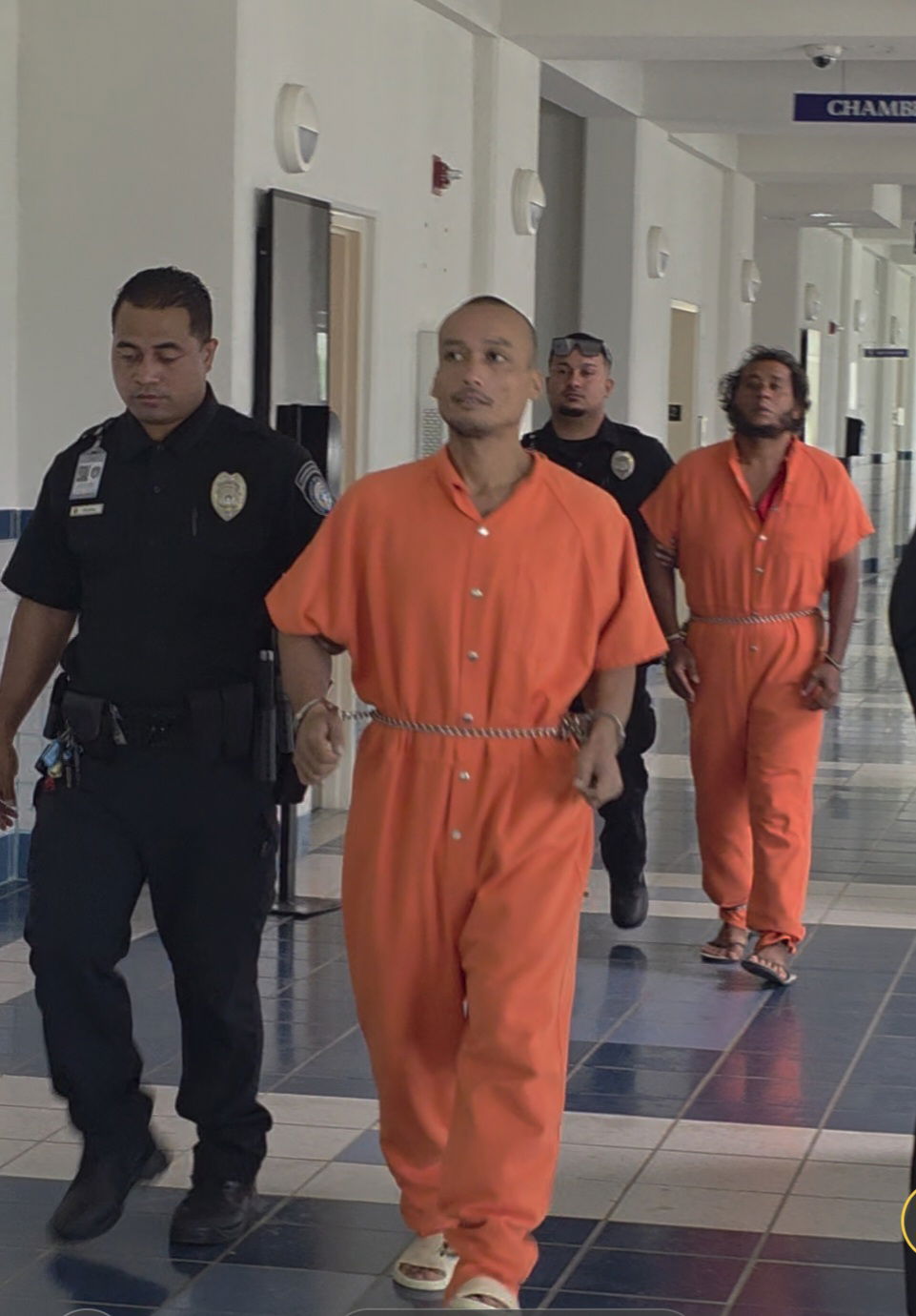 Vincent Deleon Guerrero is escorted by a Corrections officer to a bail hearing on Monday. Following behind is another defendant in custody, Olngescheng Iked Mengidab.Photo by Bryan Manabat