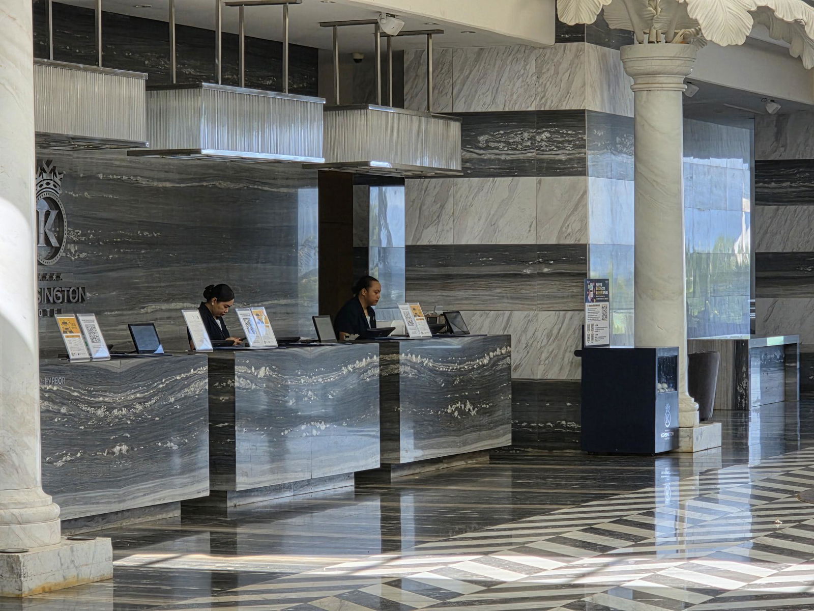 Receptionists are seen in the lobby of Kensington Hotel Saipan on Wednesday.Photo by Bryan Manabat