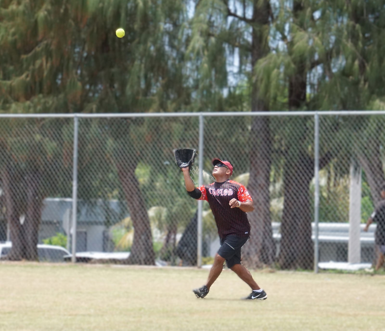 Cholo Familia’s Dan Joab stretches to catch a flyout during a game in the Masters Division of the 2025 Budweiser Belau Amateur Softball Association League at the Dandan ballfield.Photo by James F. Sablan Jr.