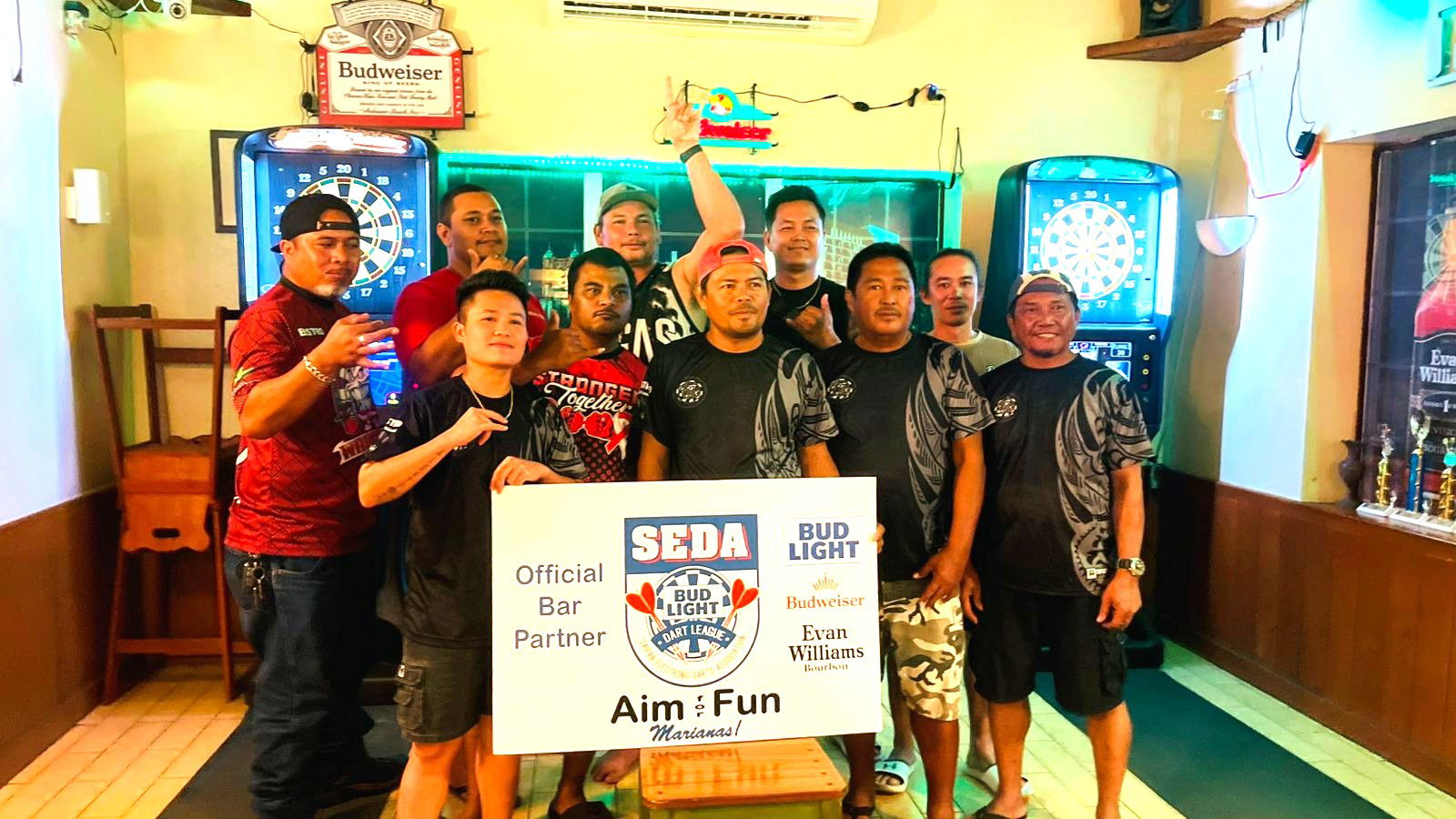 Bistro Waschobw and Bistro High Caliber 2.0 players pose for a group photo after their match in the Thursday Fanihi Division of the 2025 SEDA Bud Light Dart League at the Bistro in Garapan on Thursday night.Contributed photo