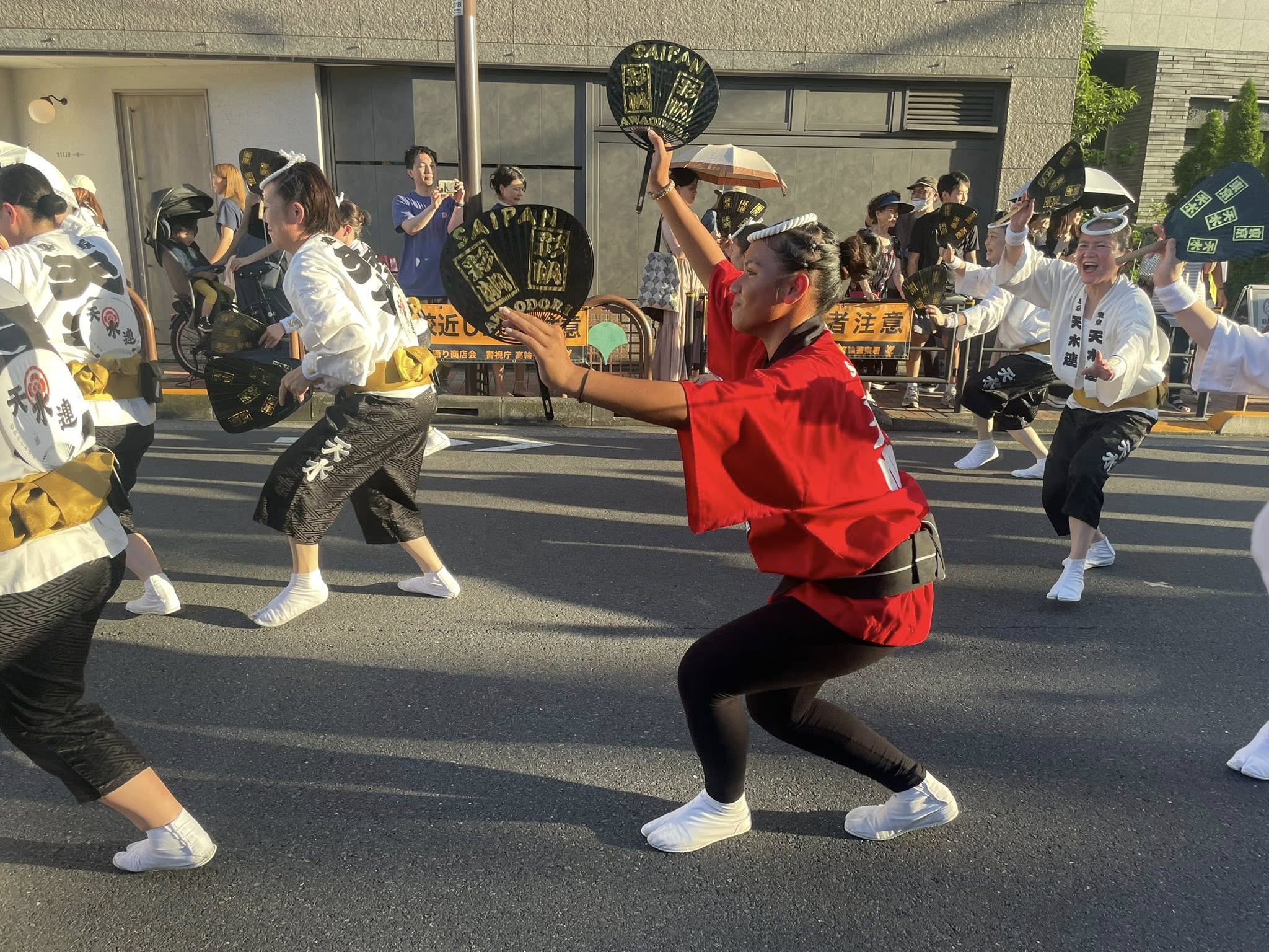 Saipan Awaodori Team's Connie Mettao joins Japanese Awaodori dancers at the Shirokane Awaodori Festival.