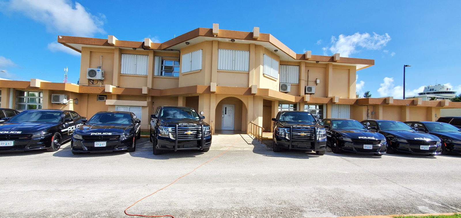 Police vehicles are parked at the Department of Public Safety headquarters in Susupe.