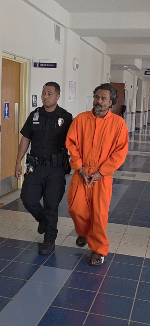Newton Tmarsel is escorted by a Corrections officer to a bail hearing on Monday.Photo by Bryan Manabat