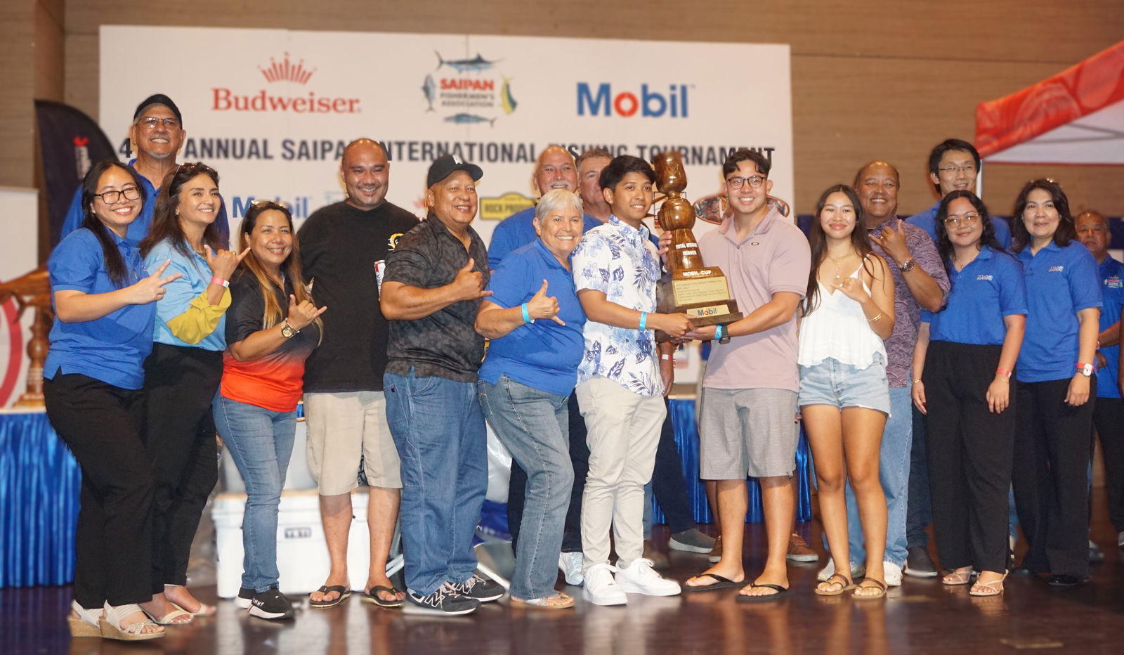 Lady V crewmembers pose alongside Saipan Fishermen's Association's board members as the Mobil Cup (total weight) category winner during the awards banquet for SFA’s 41st Saipan International Fishing Tournament at the Taga Hall of Saipan World Resort on Monday night.