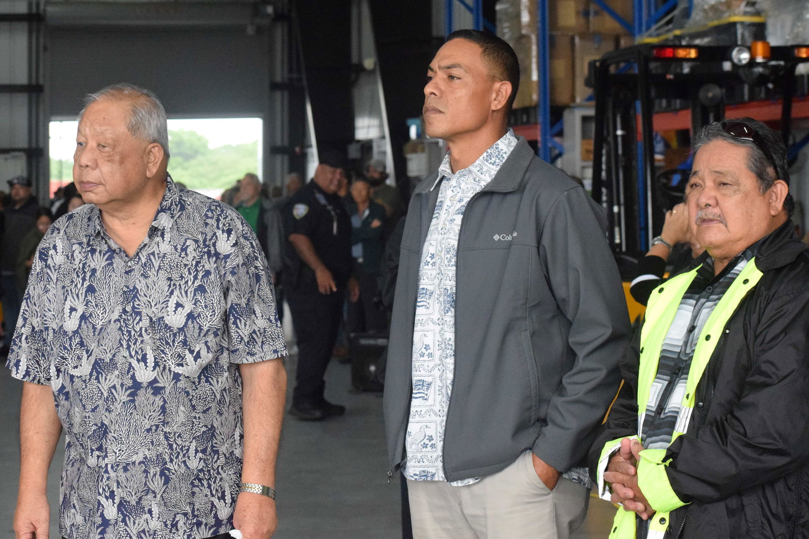 Gov. David M. Apatang, Lt. Gov. Dennis James C. Mendiola and Chief Justice Alexandro Castro wait for the arrival of Gov. Arnold I. Palacios’s remains at the MACS hangar.