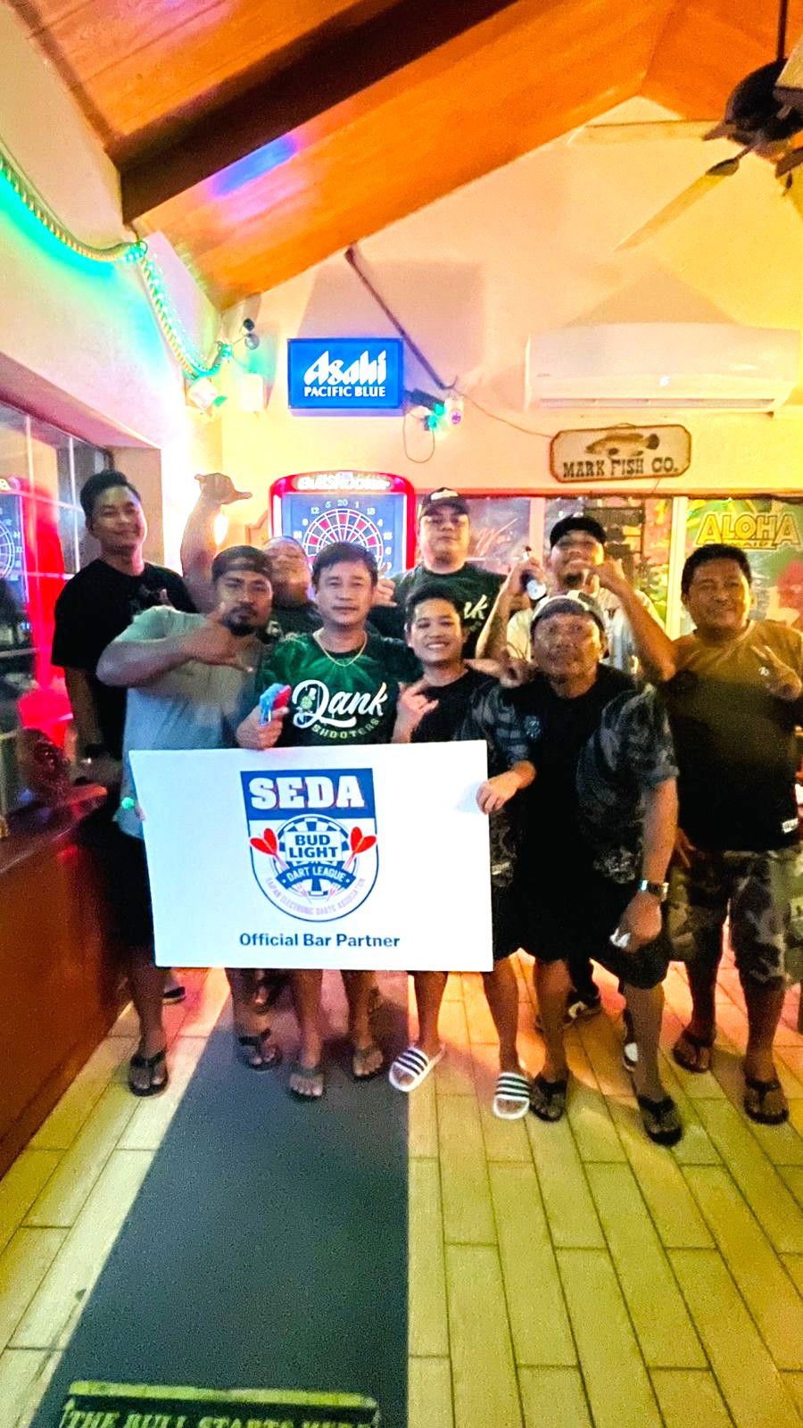 9 Eleven Dank Shooters and Bistro High Caliber 2.0 players pose for a group photo after their match in the Fanihi B Division of the 2025 SEDA Bud Light Dart League at the Bistro in Garapan on Thursday night.Contributed photo