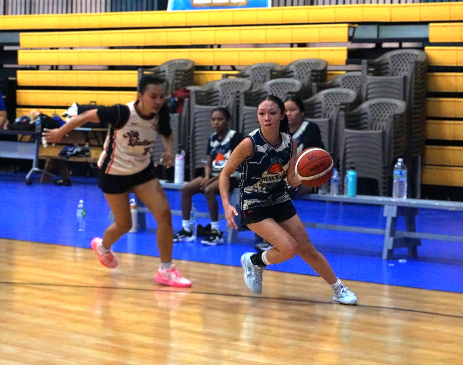 Hericanes' Kaia Travilla dribbles past a defender during a semifinals game against Air Ballers in the women’s division of the 2025 Allied Pacific Environmental Consulting Basketball League at the Ada gym on Saturday afternoon.Photo by James F. Sablan Jr.