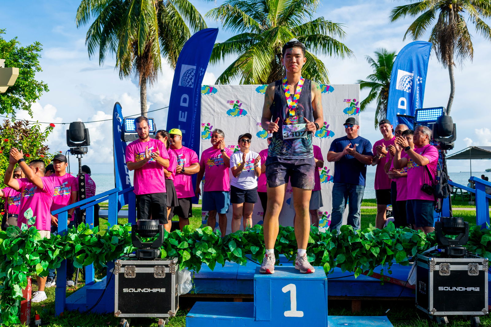 Pony Tang poses for a photo as the overall first-place finisher during the awards ceremony of the Triple J 5K Bubble Color Run at American Memorial Park.