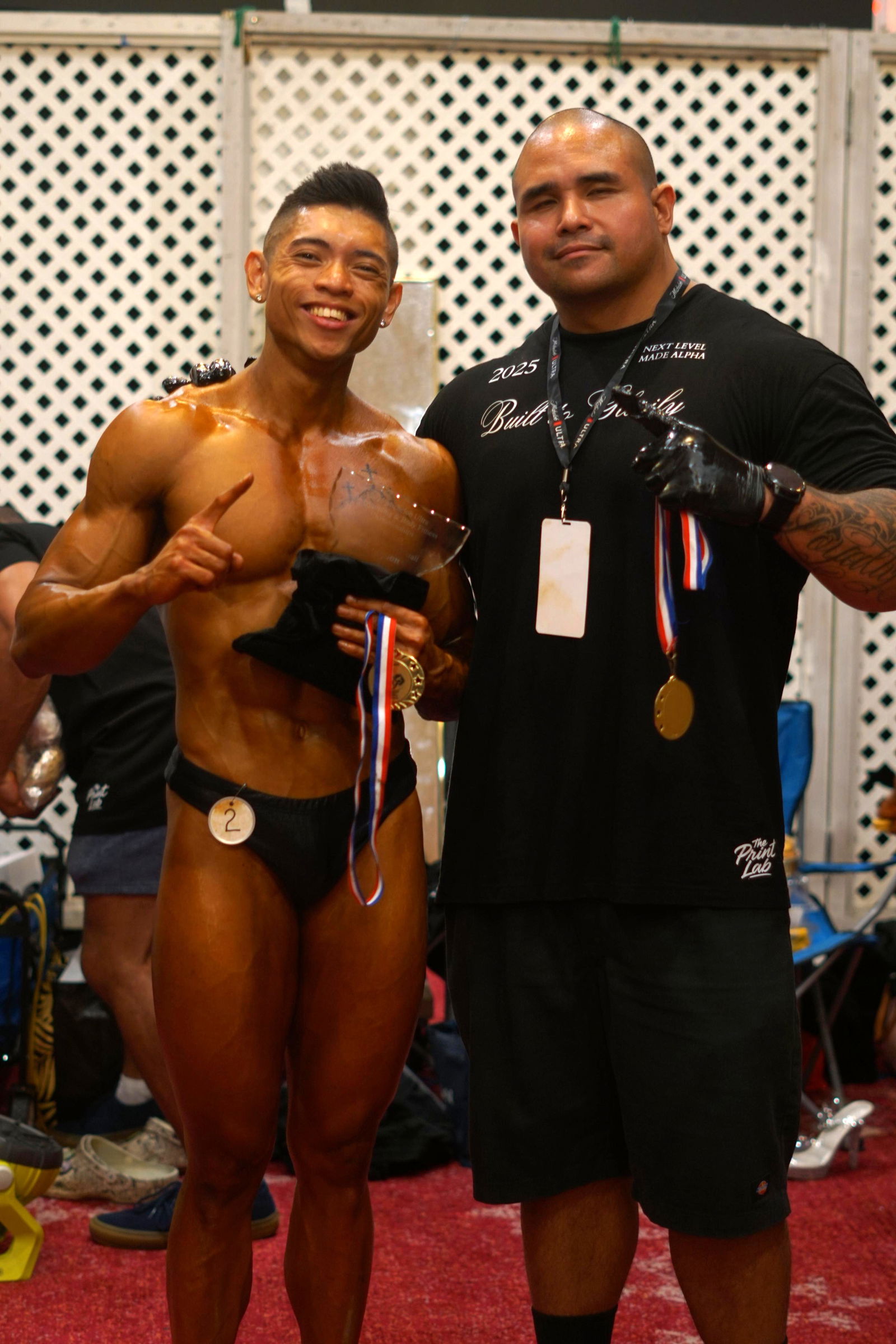 Jerome Diyco displays his awards with Coach Mike Duay during the 2025 NPC Guam National Bodybuilding Championship at the Royal Rhiga Resort Guam on Saturday, June 21.Contributed photo