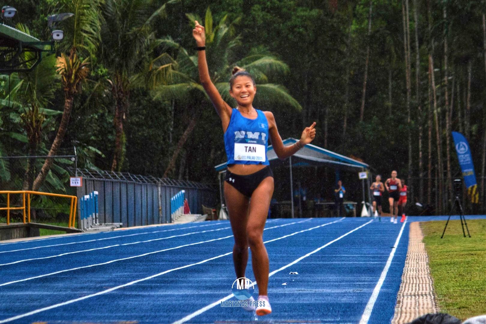 Tania Tan smiles as she nears the finish line of the 10,000m race in the 2025 Pacific Mini Games at the Palau National Track and Field on Friday.Marianas Press via NMSA