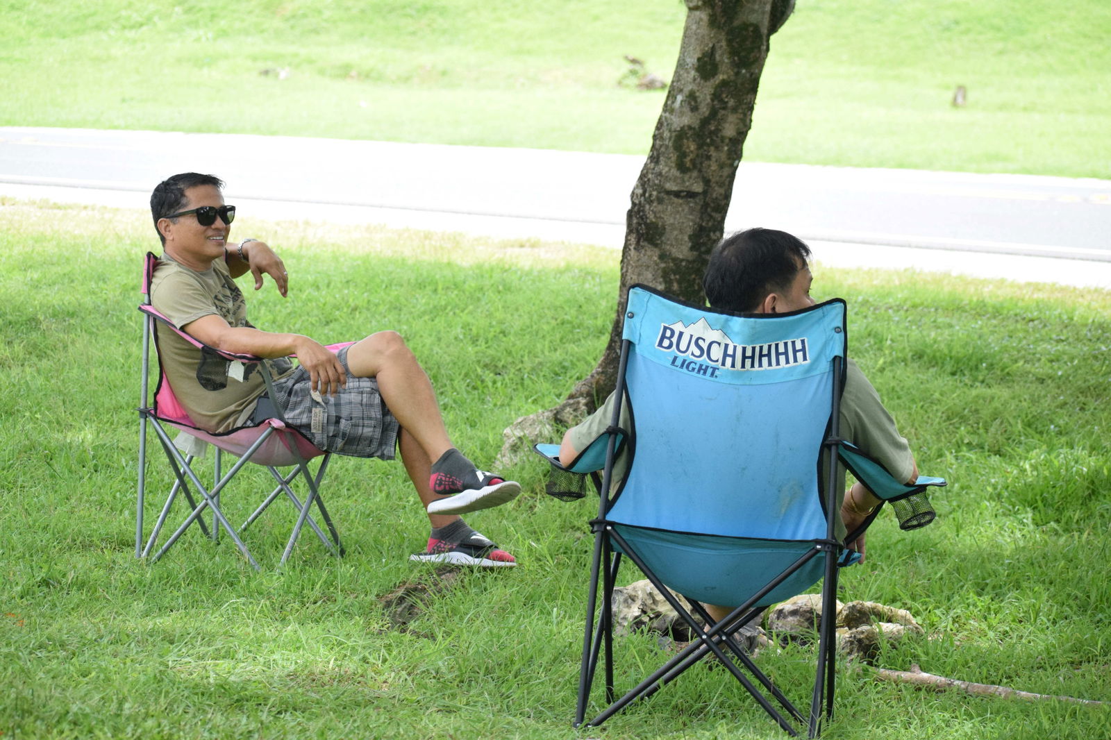 Nel Mercado and Richard Lagado sit under a tree on Capital Hill, where they evacuated for safety on Wednesday.Photo by Emmanuel T. Erediano
