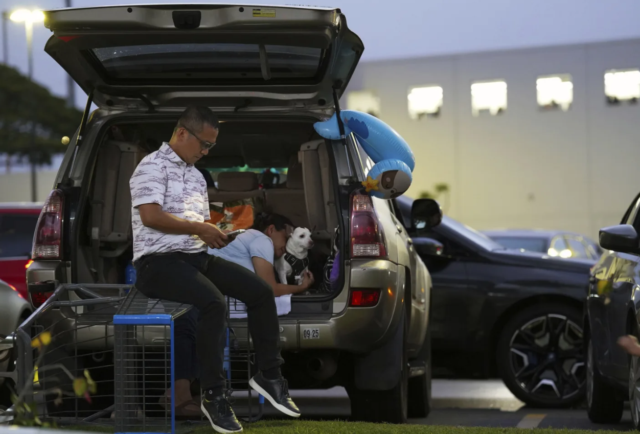 Oahu residents seek refuge from the threat of tsunami in a Walmart parking lot in Kapolei, Oahu, Hawaii, Tuesday, July 29, 2025.