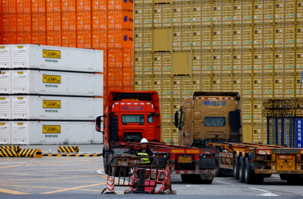 A member of the security personnel stands guard at an entrance to a container logistics center at the Yantian port in Shenzhen, Guangdong province, China on May 9, 2025.REUTERS