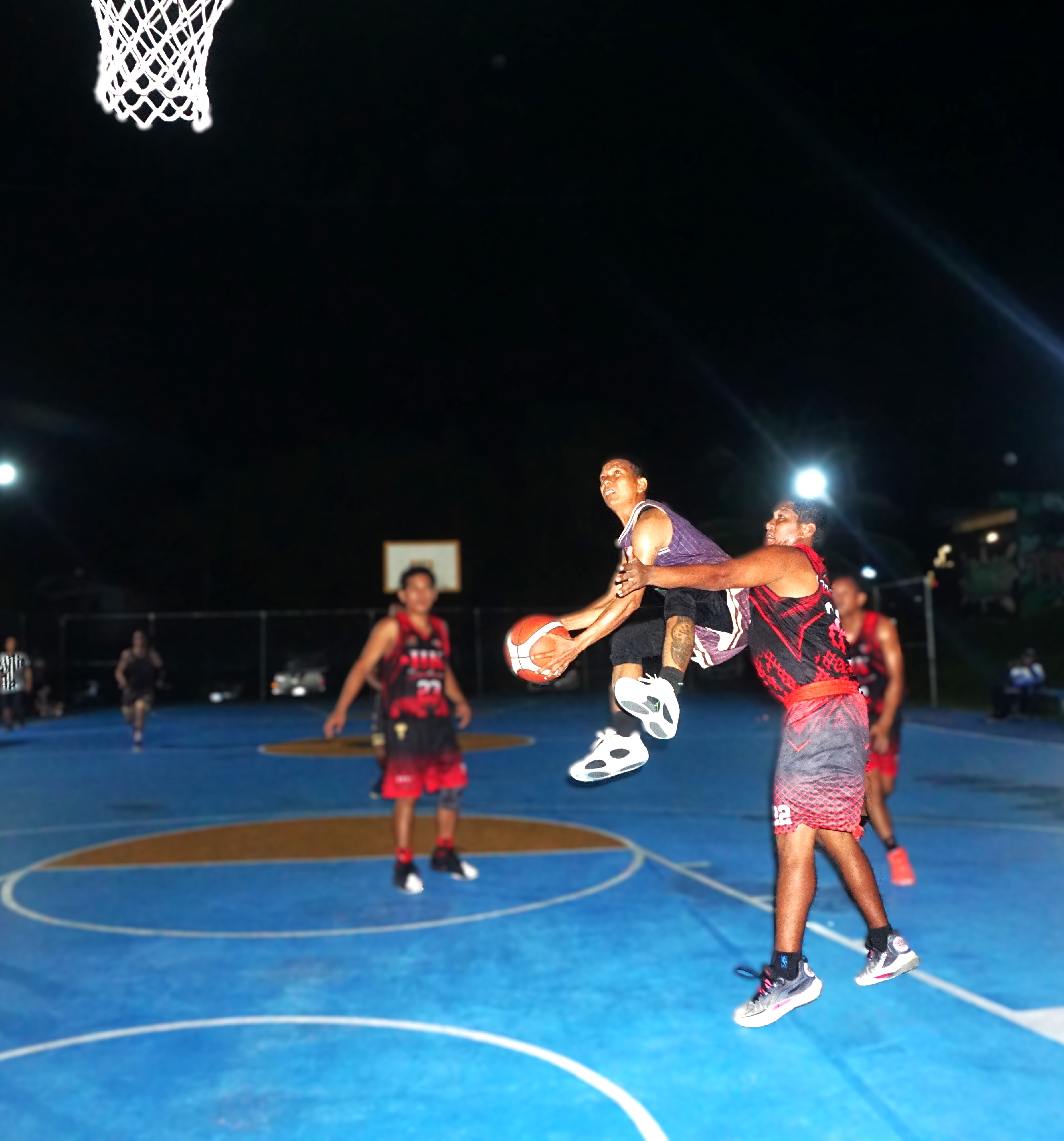 Top Shelf/Connie's BBQ's Jomar Tengco protects the ball as he goes up for the layup during a game against Yabangis/HK in Bracket A of the CNMI E-Sports Invitational Basketball League 2025 at the Gualo Rai Basketball Court on Saturday night.