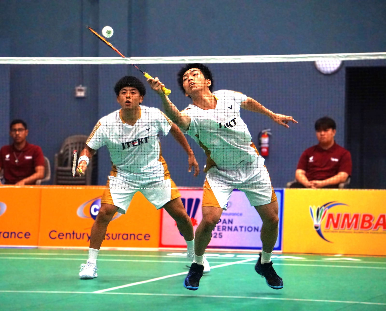 Japan's Naoya Kawashima reaches out to keep the possession alive alongside teammate Akira Koga during the Men's Doubles championship match of the Century Insurance Saipan International 2025 at the Ada gym on Saturday.Photo by James F. Sablan Jr.