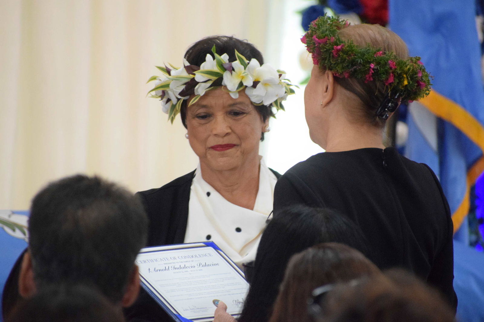 Guam Gov. Lou Guerrero presents a certificate of condolences to First Lady Wella Palacios.