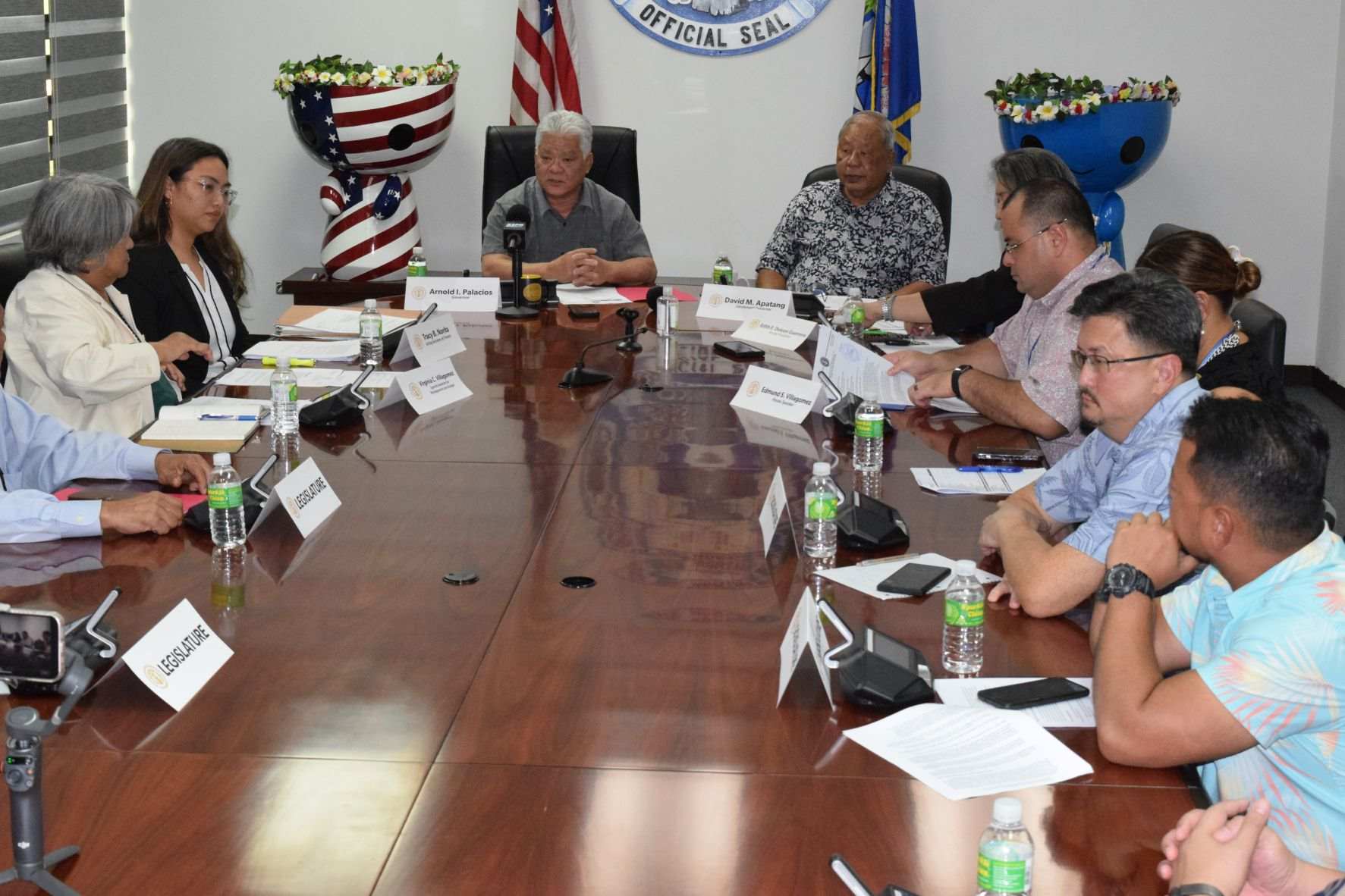 Gov. Arnold I. Palacios speaks as members of the cabinet and lawmakers listen during a press conference in March 2023.
