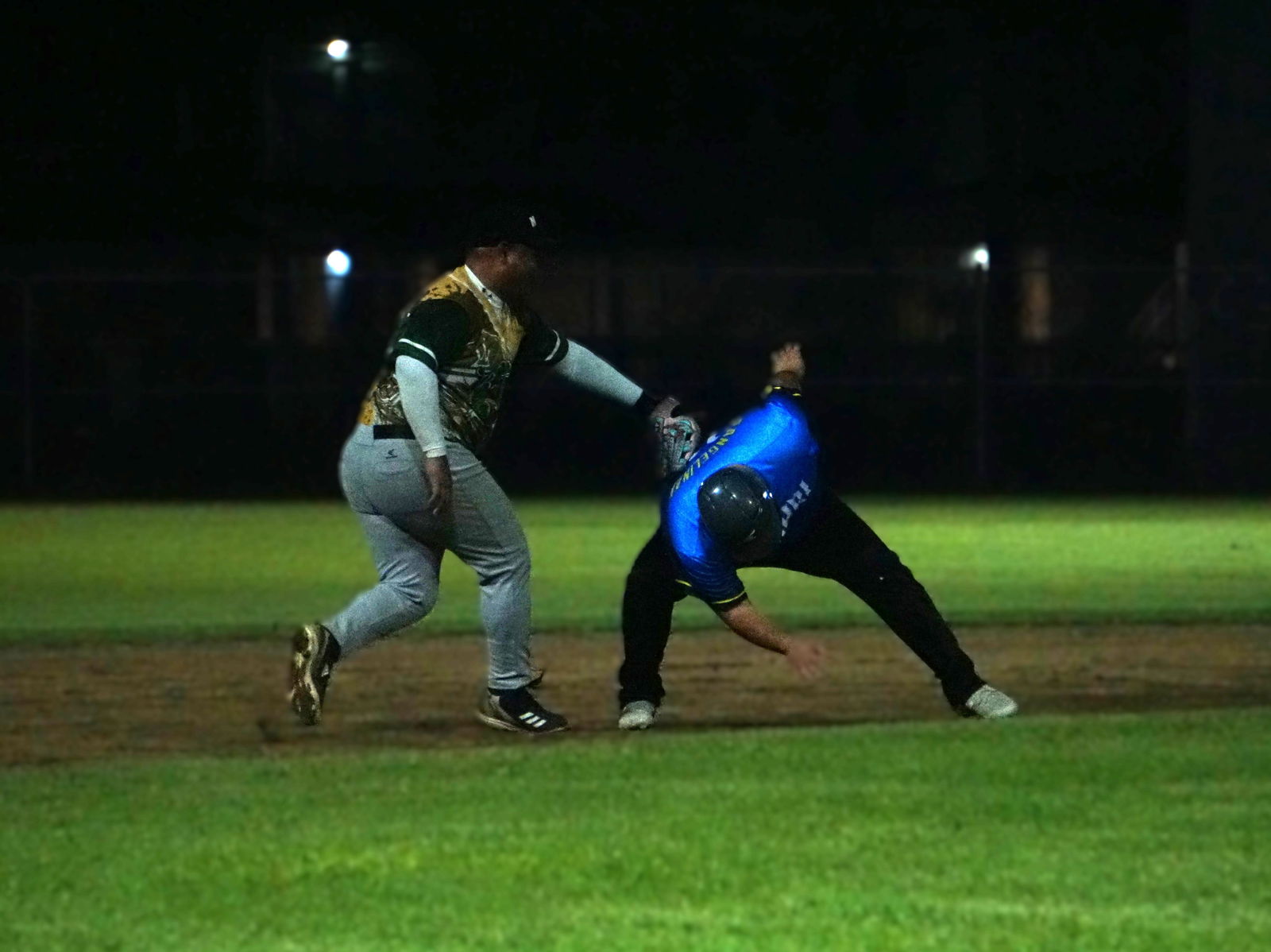Bandits third baseman Harry Nakamura tags an Akkari runner during a Saipan Baseball League game at the Francisco "Tan Ko" Palacios Baseball Field on Wednesday night.