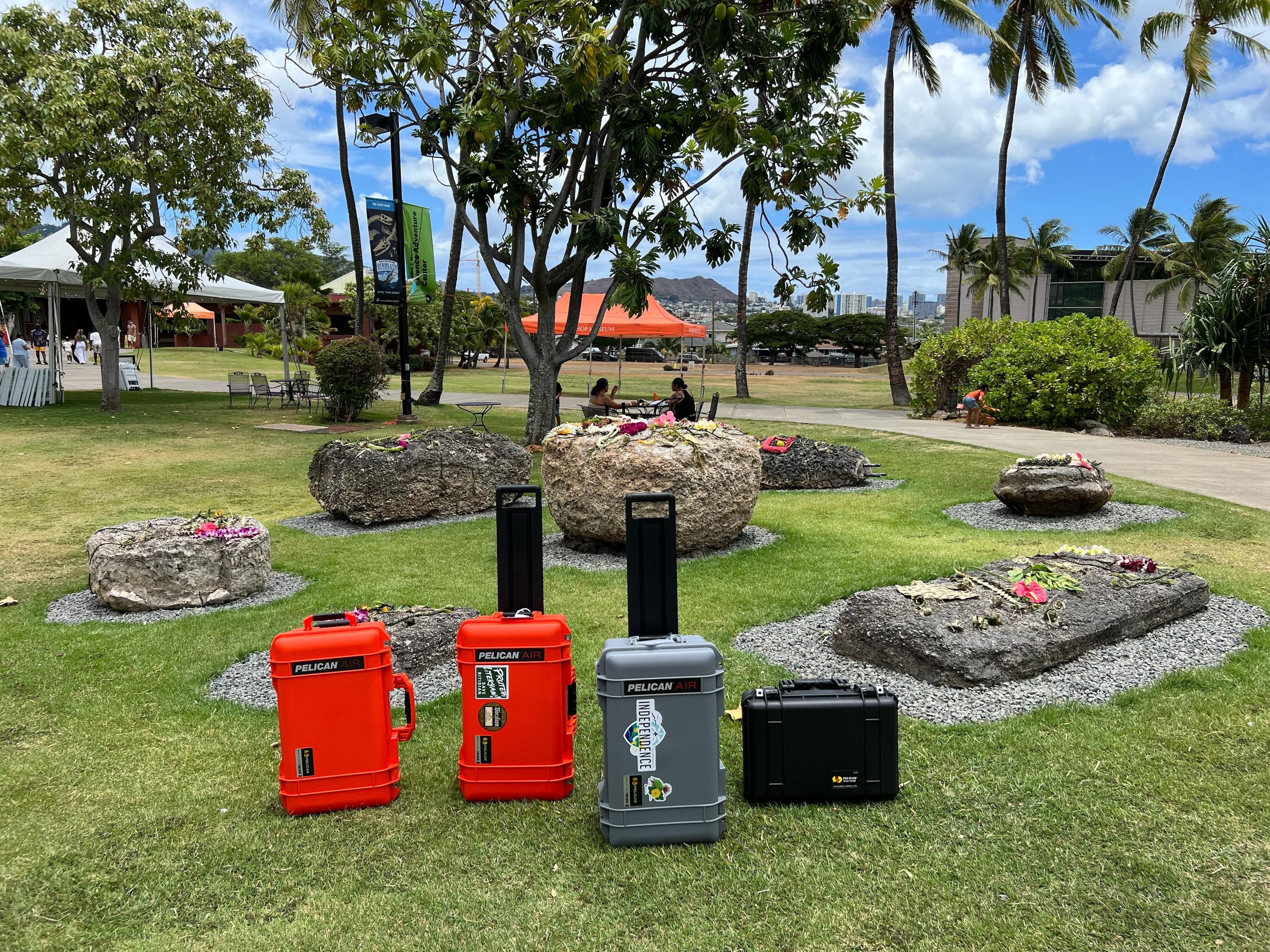 Pieces of luggage filled with artifacts stand in front of the Chamorro latte on the campus of the Bishop Museum.