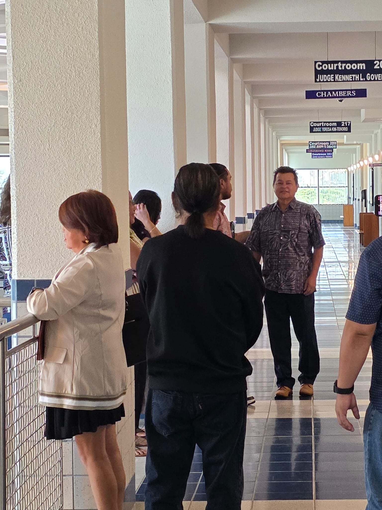 Henry Hofschneider and some family members wait outside the courtroom before Monday's arraignment.