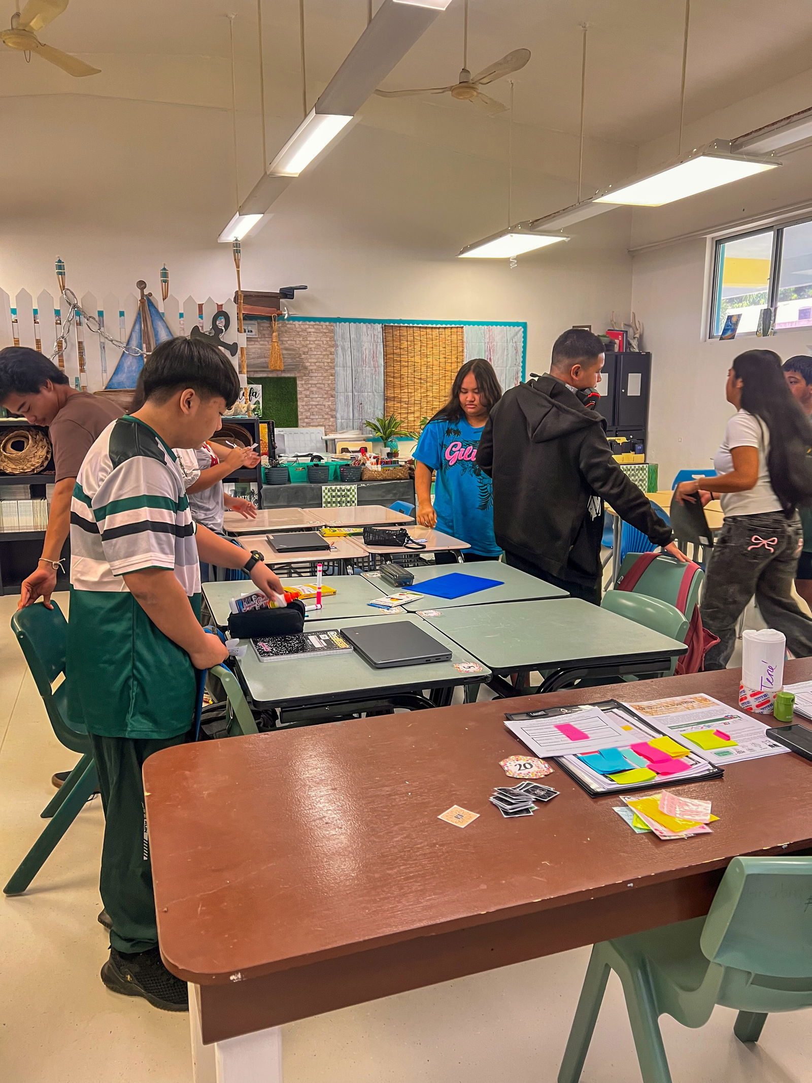 Students at Dr. Rita Hocog Inos Junior-Senior High School put away book-based and technology-driven materials at the end of their first period.