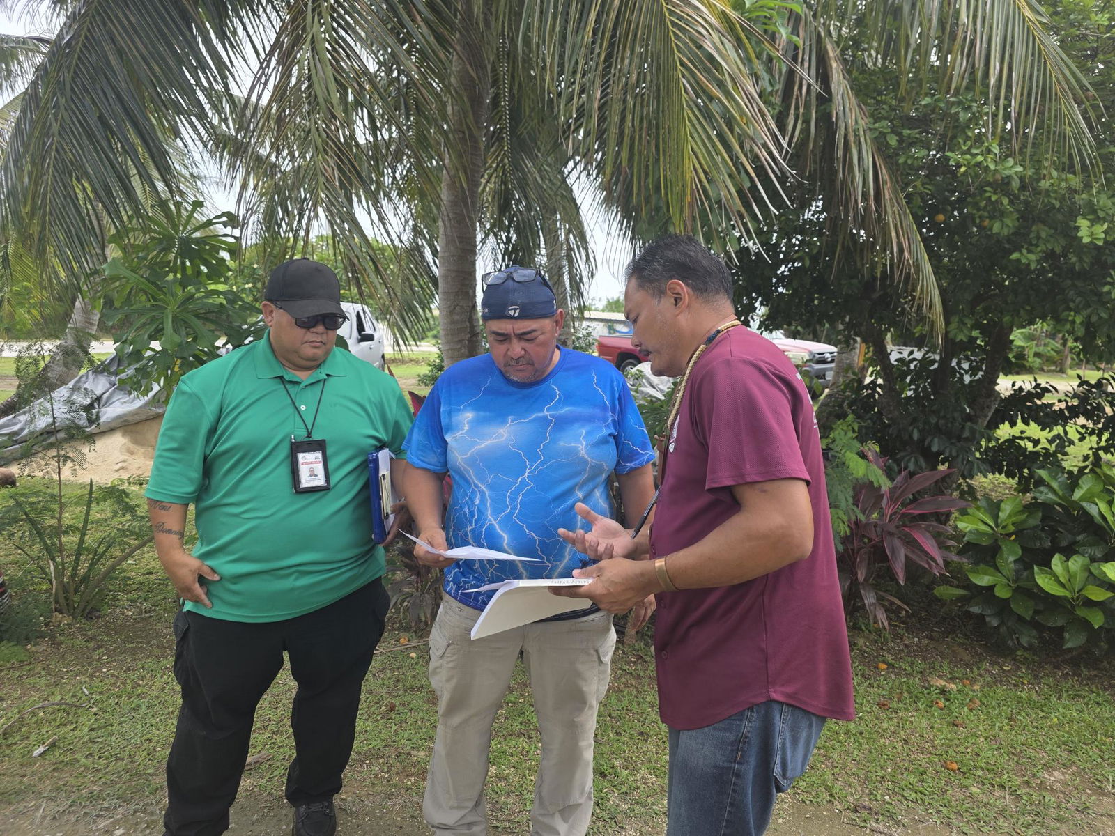 Dandan homeowner Patrick Cepeda, center, speaks with Chief Enforcement Officer Yubert M. Alepuyo and Christopher Borja of the Zoning Office on Tuesday.Photo by Bryan Manabat