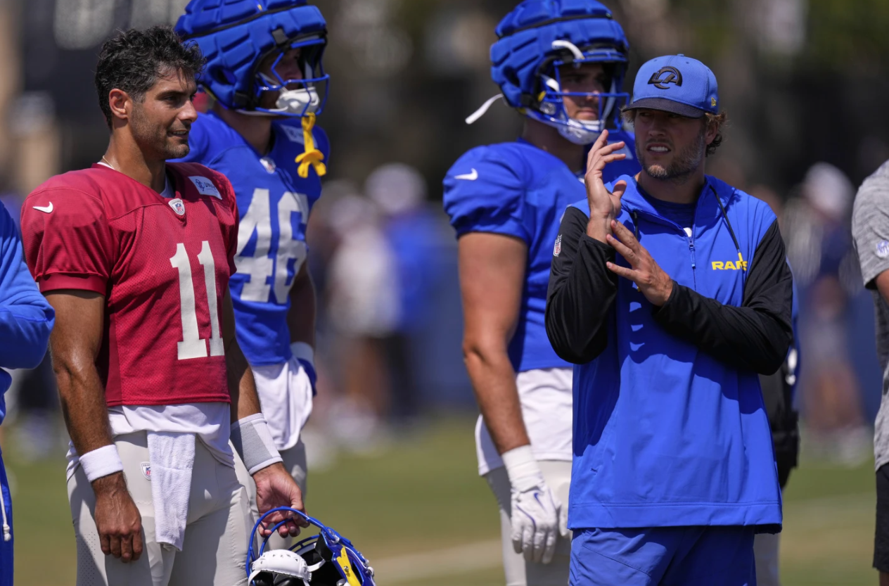 Los Angeles Rams quarterback Jimmy Garoppolo, left, talks with quarterback Matthew Stafford during a training camp scrimmage against the Dallas Cowboys on Aug. 5, 2025 in Oxnard, Calif.AP
