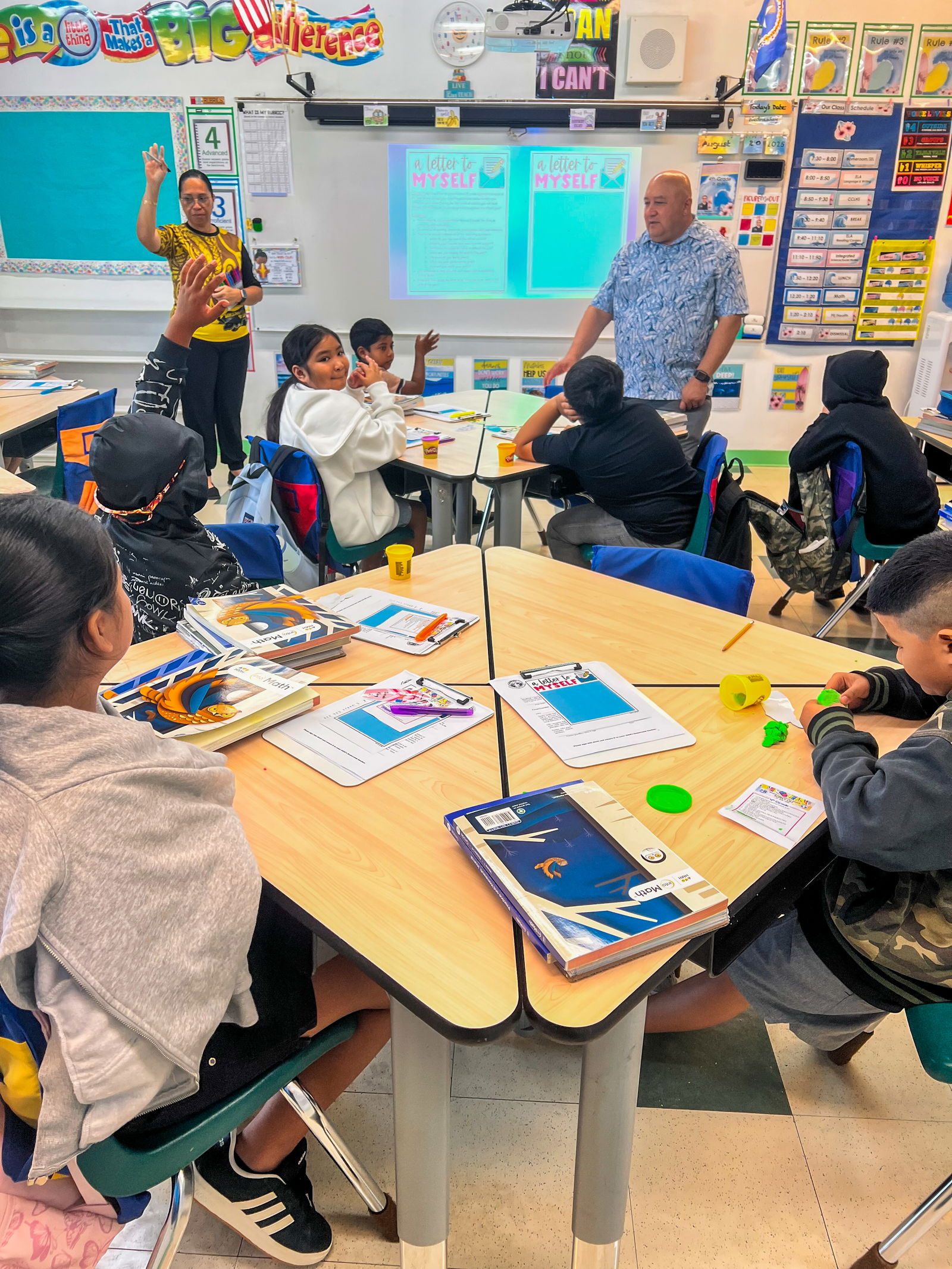 Students in Lorna Calvo King’s class at Sinapalo Elementary School participate in an “A Letter to Myself” activity as Education Commissioner Dr. Lawrence F. Camacho looks on.
