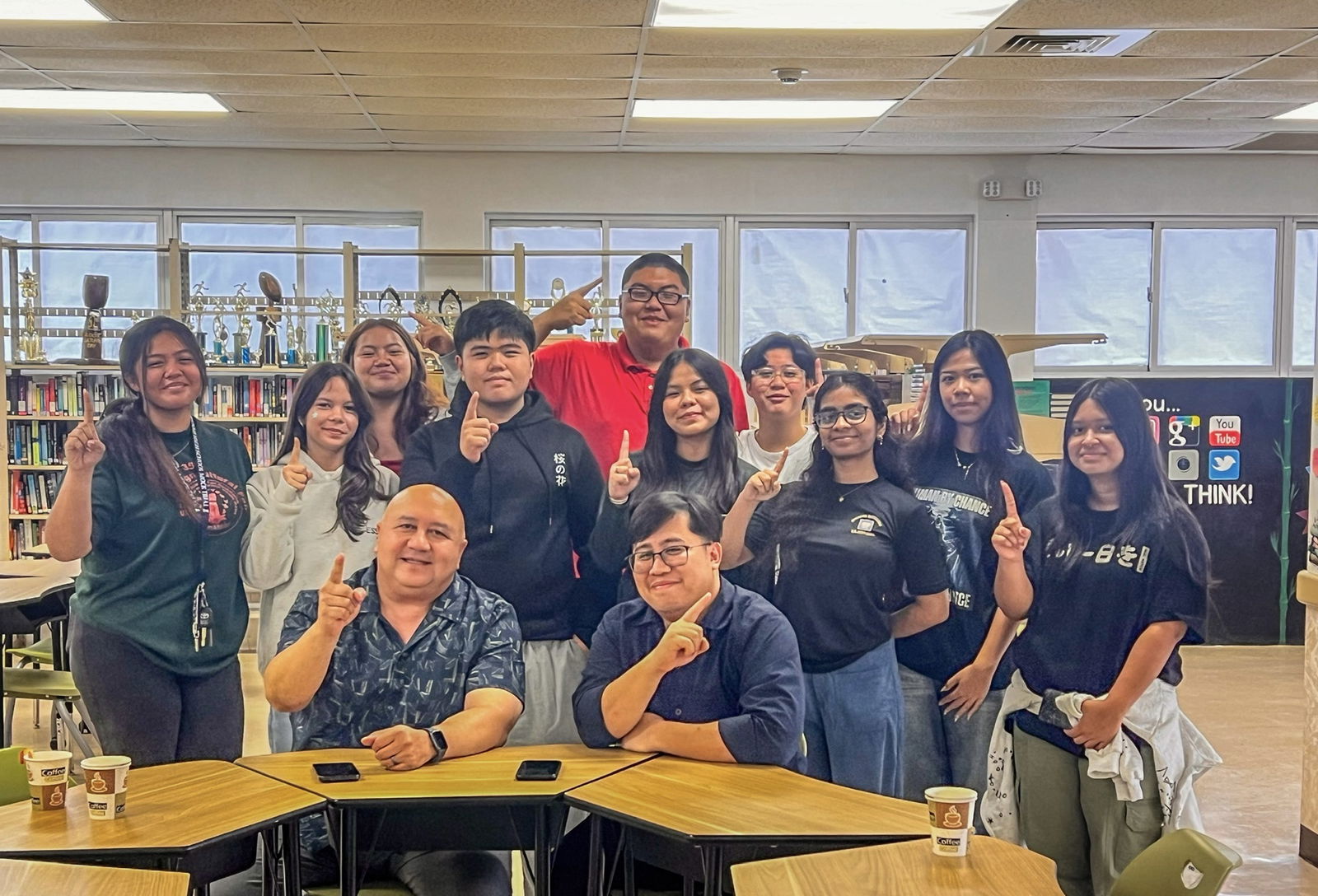 At Tinian High School library, student leaders flash the No. 1 sign to represent the Public School System’s motto, “Students First,” as they pose with Commissioner of Education Dr. Lawrence F. Camacho and Acting Principal Edward Hofschneider.