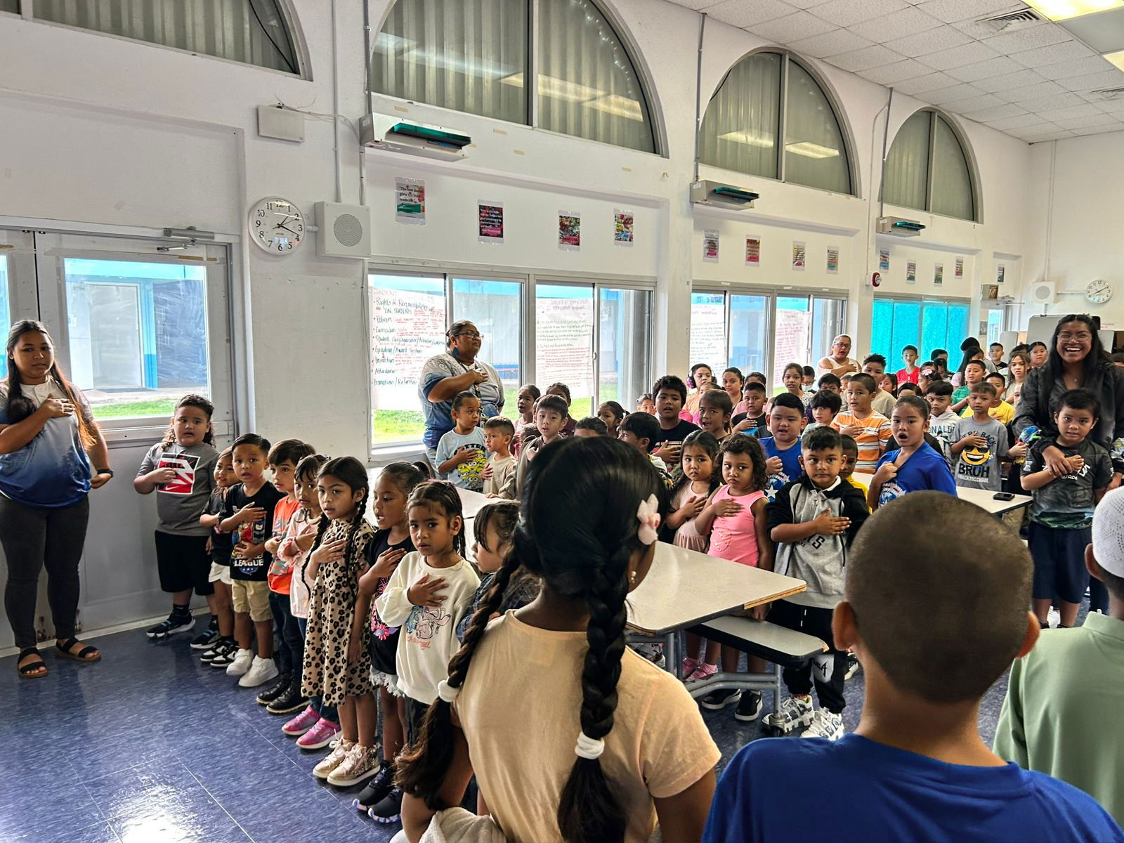 Tinian Elementary School students sing the national anthem in their school cafeteria.