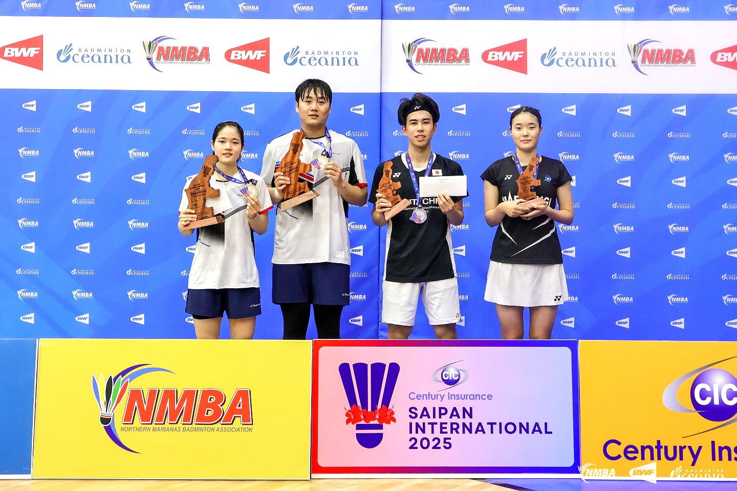 Korea’s An Yun Seong and Lee Yu Lim, along with Japan’s Kenta Matsukawa and Riko Kiyose, pose as the champions and runners up in the Mixed Doubles event of the Century Insurance Saipan International 2025 at the Ada gym on Saturday.NMBA photo