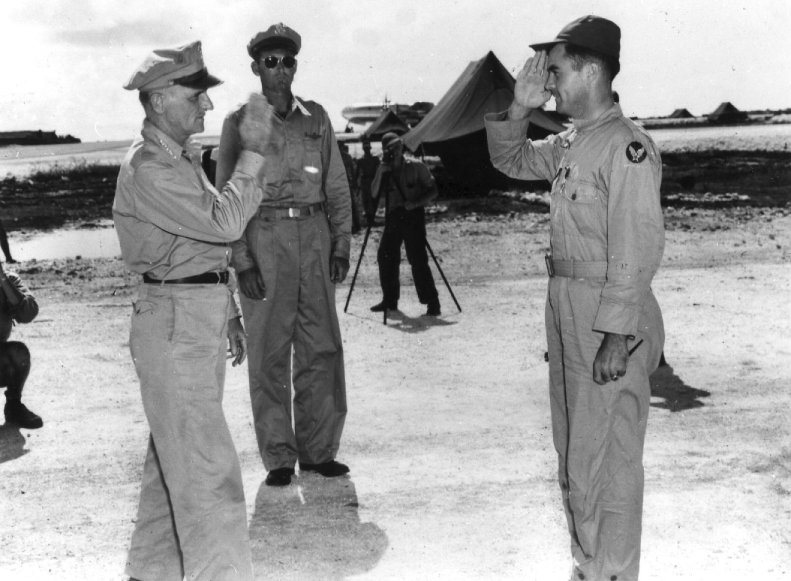 Col. Paul Tibbets, right, salutes Gen. Carl Spaatz.