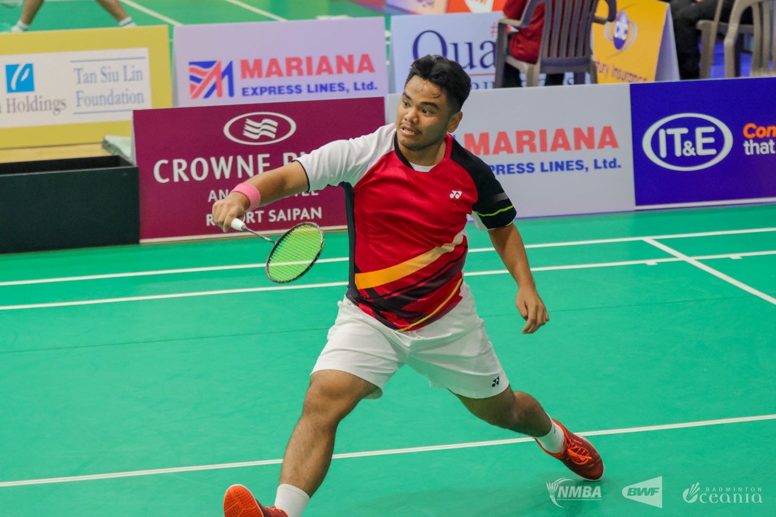 NMI's Daniell Pablo steps forward for the backhand return during his debut match in the men's singles event of the Crowne Plaza Northern Marianas Open 2025 at the Ada gym on Tuesday.Northern Marianas Badminton Association photo