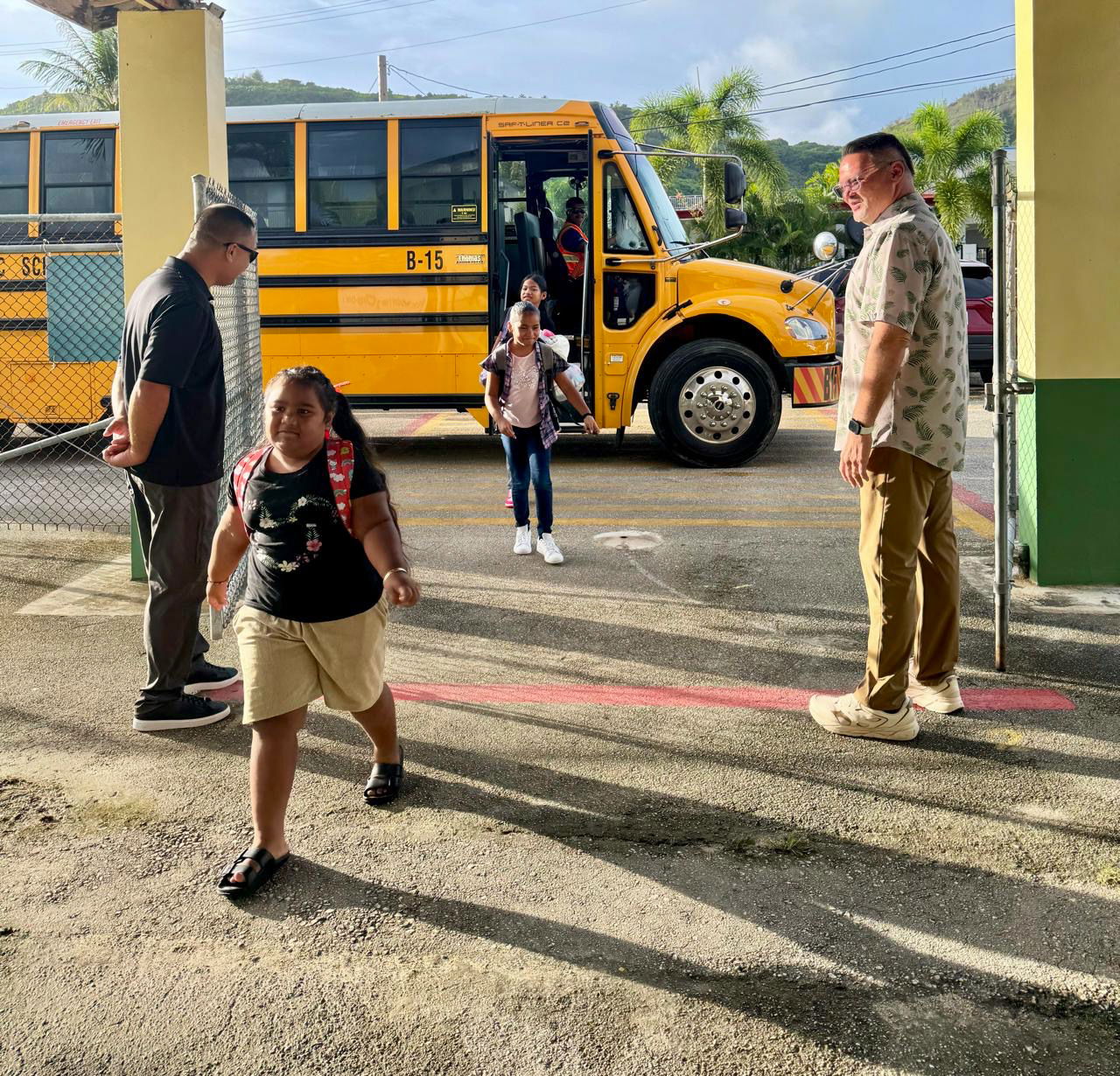 GTC Elementary School Principal Derwin Johnson and State Infrastructure Technology Director Jesse Tenorio welcome students back to campus.