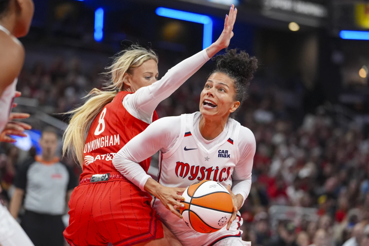 Washington Mystics forward Alysha Clark looks to shoot around Indiana Fever guard Sophie Cunningham in the second half of a WNBA game in Indianapolis, Friday, Aug. 15, 2025AP