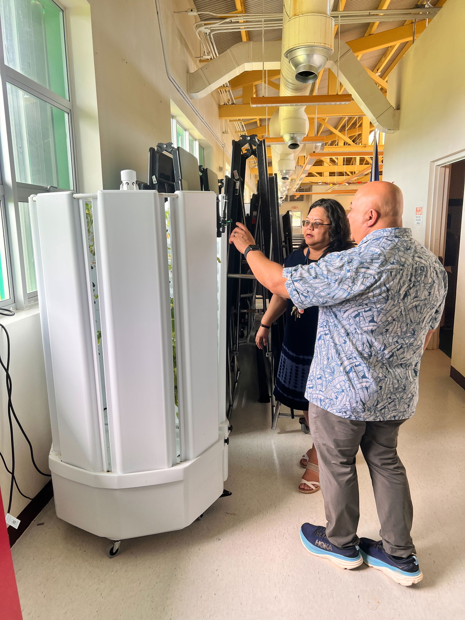 Sinapalo Elementary School Principal Daisy Quitugua shows Commissioner of Education Dr. Lawrence F. Camacho the indoor hydroponic farming pod set up on campus. The innovative pod is one of four pioneered by PSS’s Child Nutrition Program on Rota, Tinian, and Saipan.
