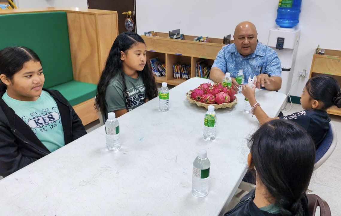 Commissioner of Education Dr. Lawrence F. Camacho talks with Koblerville Elementary School students on their first day of school.