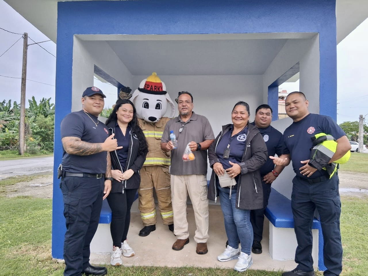 At a bus stop in Songsong, Board of Education Vice Chairman Anthony Dela Cruz Barcinas, center, poses for a photo with personnel from the Department of Public Safety, the Department of Fire and Emergency Medical Services, and the Commonwealth Health Care Corporation-Systems of Care Program on the first day of classes on Rota.