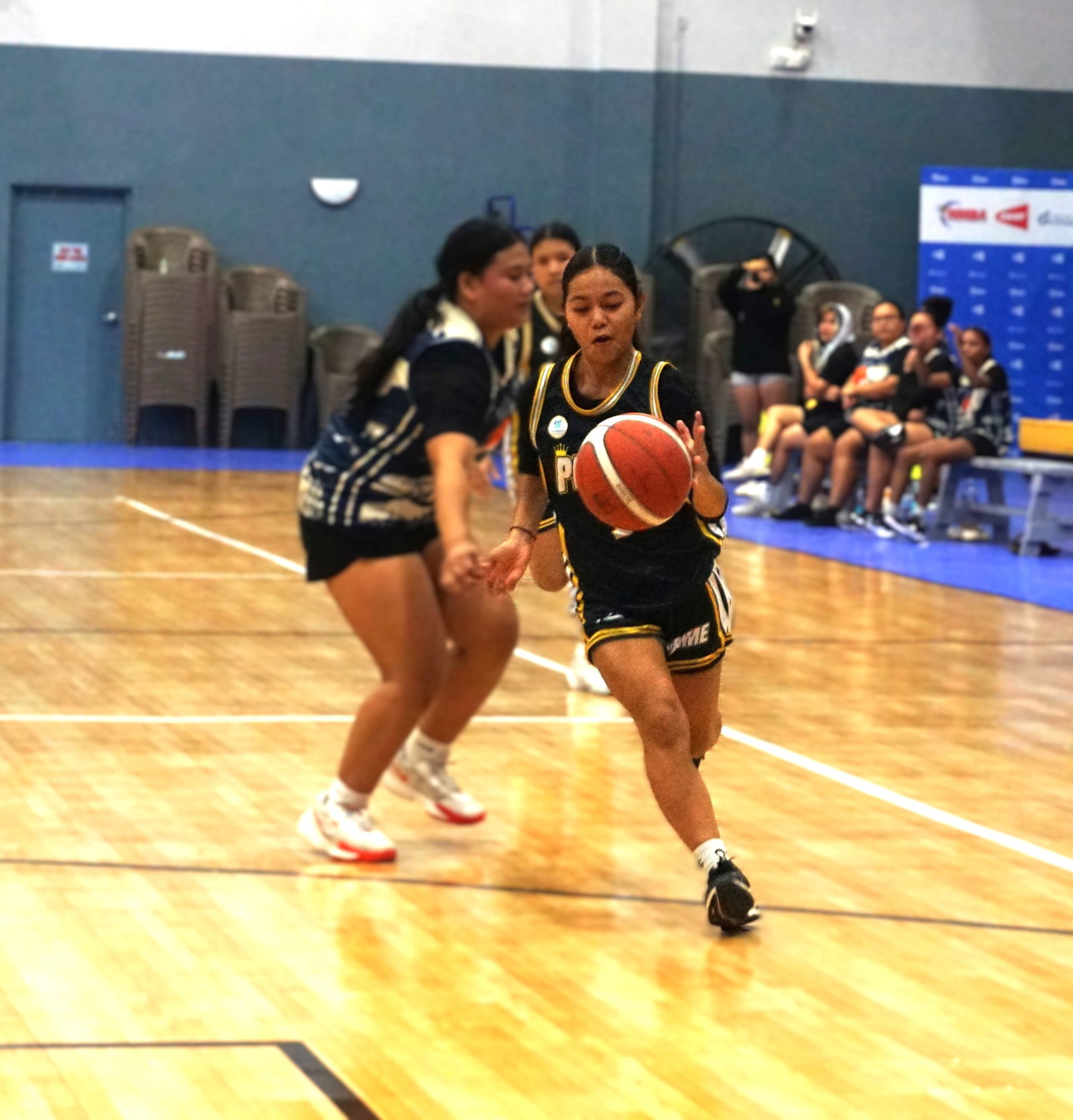 Prime's Shaenna Yamada dribbles past a defender during a championship game against the Hericanes in the women's division of the 2025 Allied Pacific Environmental Consulting Basketball League at the Ada gym on Thursday night.Photo by James F. Sablan Jr.