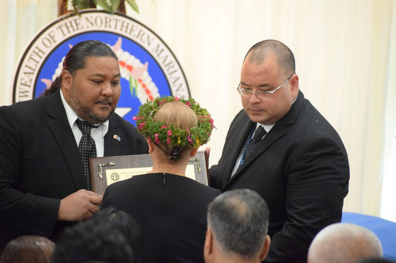 Senate President Karl King-Nabors and House Speaker Edmund S. Villagomez present to First Lady Wella Palacios a framed copy of a joint resolution in honor of the late governor.