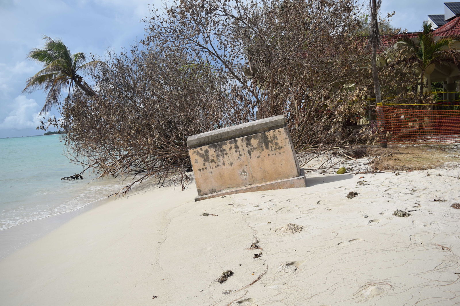 A stone marker at American Memorial Park tilts as the beach sand retreats.Photo by Emmanuel T. Erediano