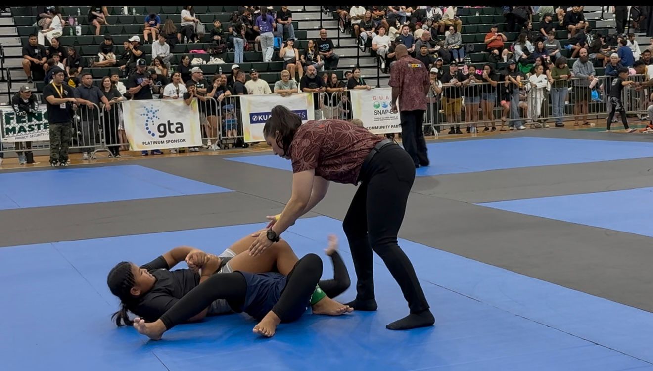 Trench Tech Purebred Saipan’s Jacqueline Quitugua attempts a rear-naked choke during her silver medal match in the Junior 1 female – No-Gi Gray Belt Division of the 2025 Påtgon Jiu Jitsu Tournament, held Saturday at UOG Field House in Mangilao, Guam.