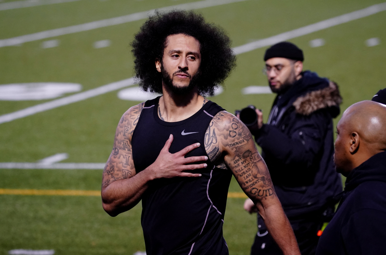 Colin Kaepernick puts his hand over his heart in response to a comment at a special training event he created to provide greater access to scouts, the media, and the public, at Charles. R. Drew High School in Riverdale, Georgia, Nov. 16, 2019.REUTERS