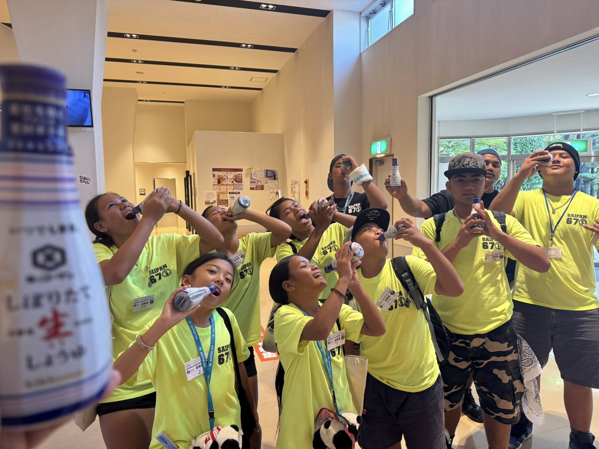 Saipan Awaodori Team members with their bottles of milk from a milk farm.