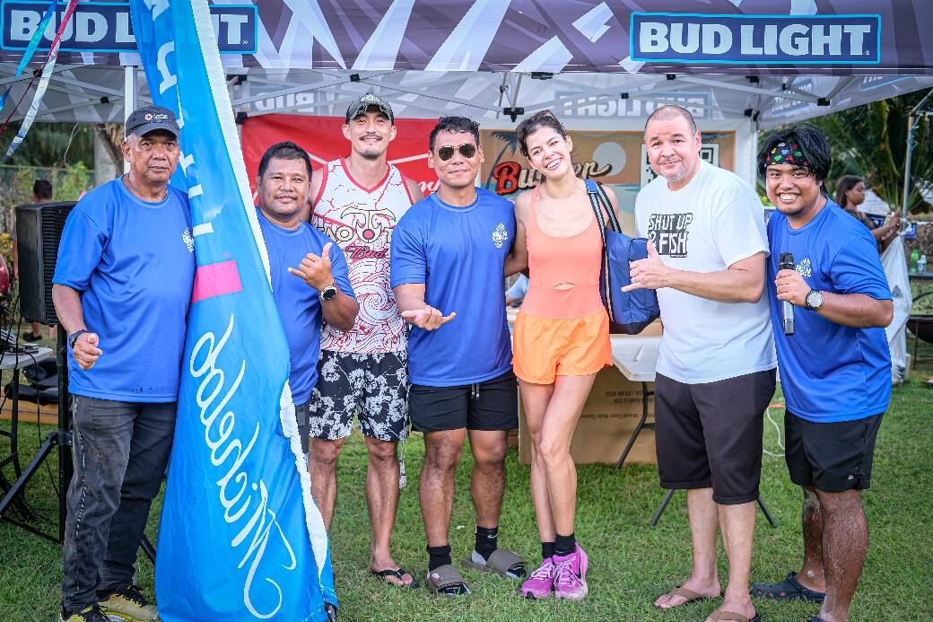 Tammy Ackerman poses alongside Marpac and Run Saipan representatives as the 1st place winner in the women's division of the Run Saipan’s 4th Annual Michelob Ultra Beer Mile at Marianas Beach Resort Saipan during the Budweiser Burger Fest on Saturday.Photo by Jonathan Sugatan