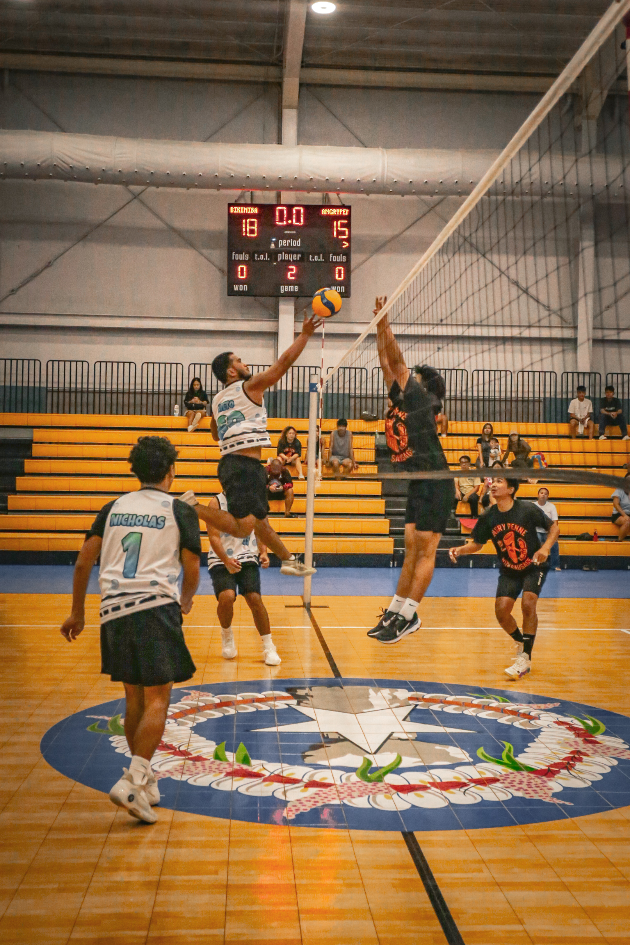Bikini Bangers' Francisco Rogopes reaches out for the return as an Angry Penne defender attempts a block during a game in the men's division of the 4 Starz Marianas Club’s 2nd Annual Fall Fest Volleyball Tournament 2025 at the Ada gym.