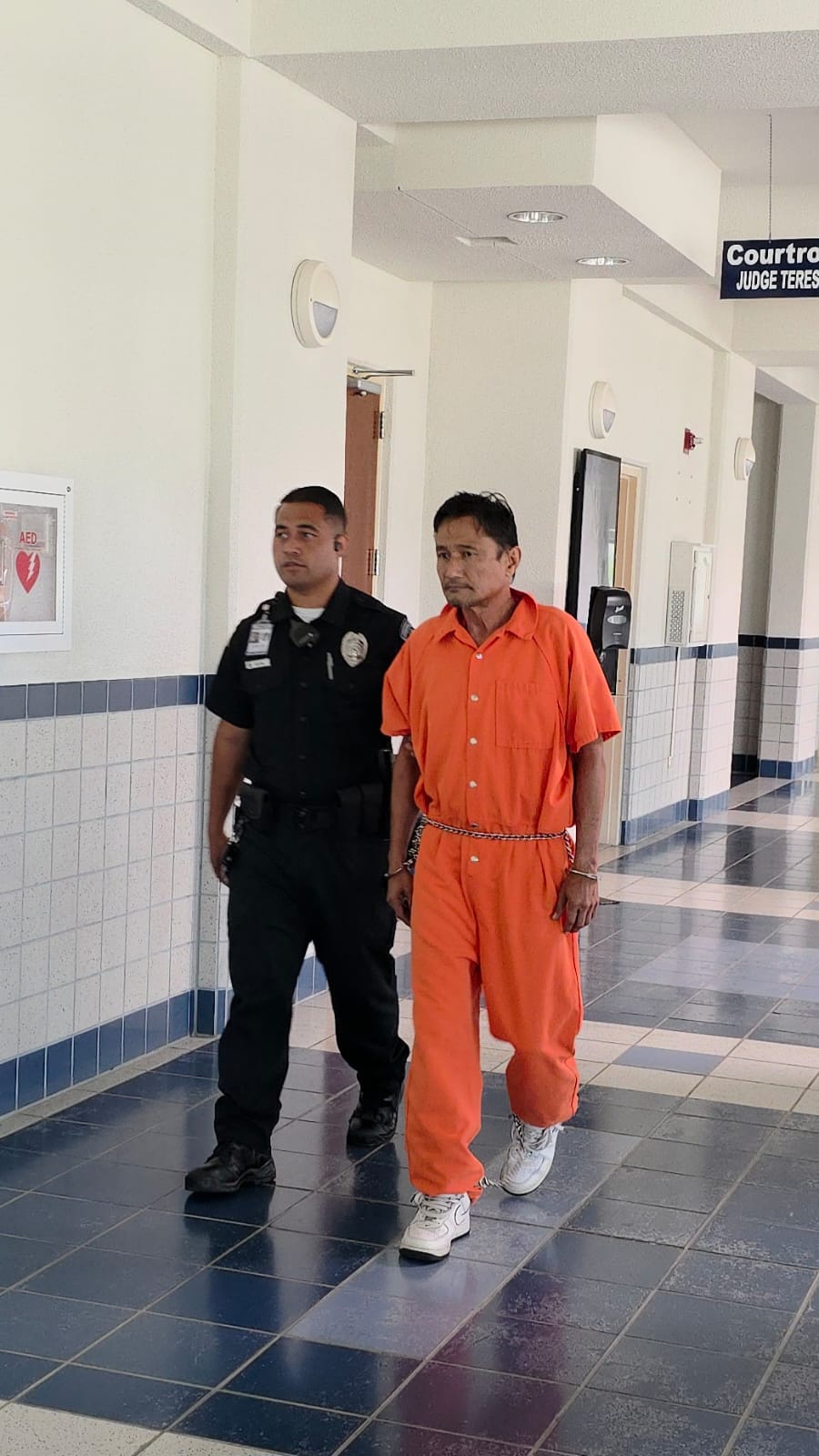 A Corrections officer escorts Raymond DLG King to a bail hearing on Monday.Photo by Bryan Manabat